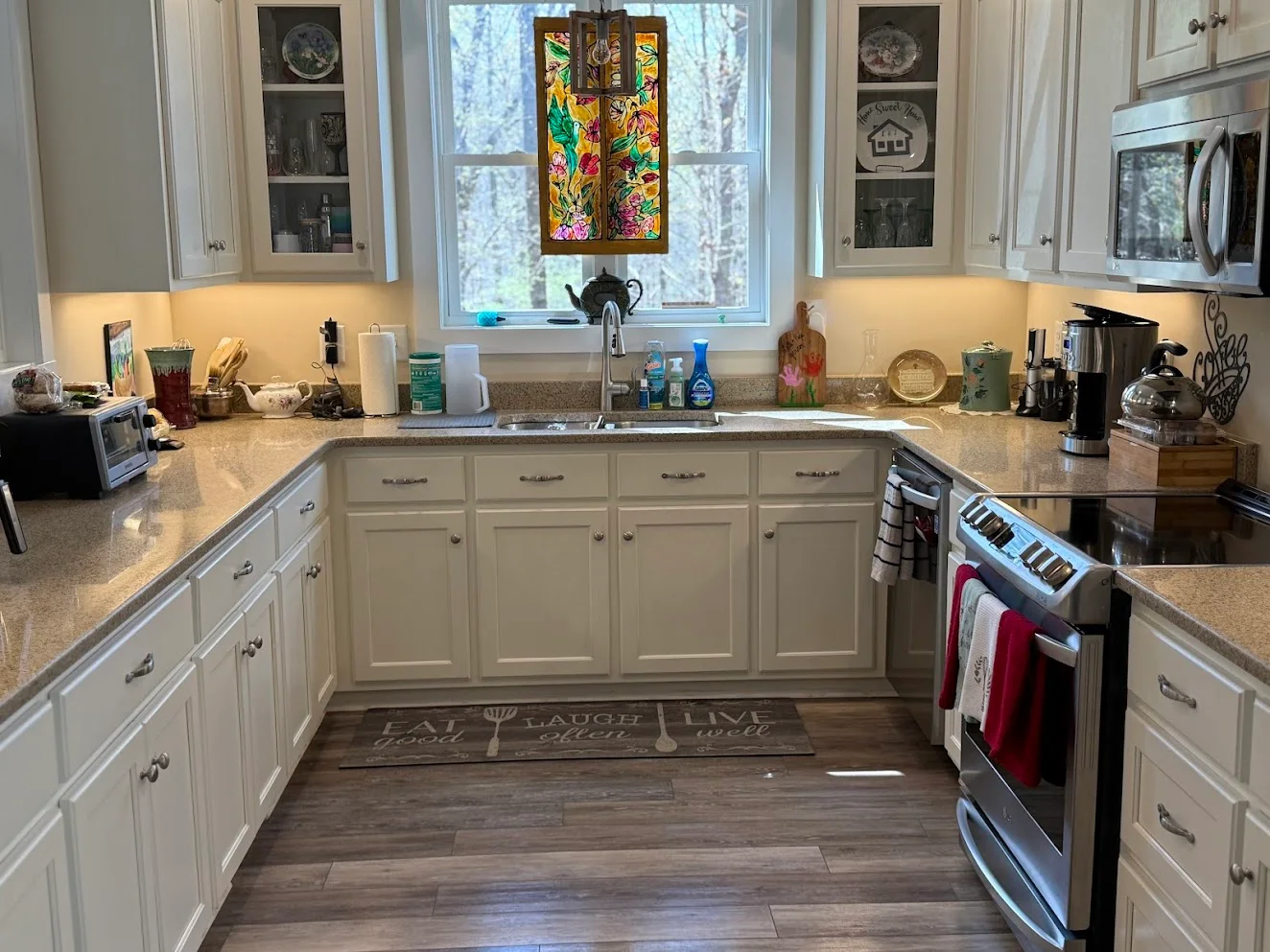 A clean kitchen with white cabinets, cleaned by the Immaculate team